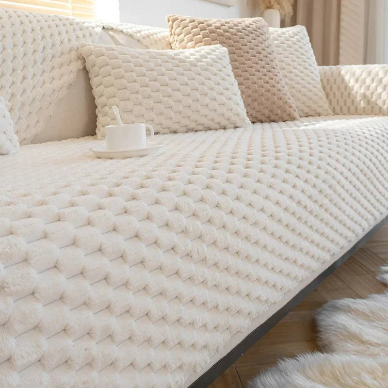Beige textured sofa cover on a couch with pillows in a living room setting.