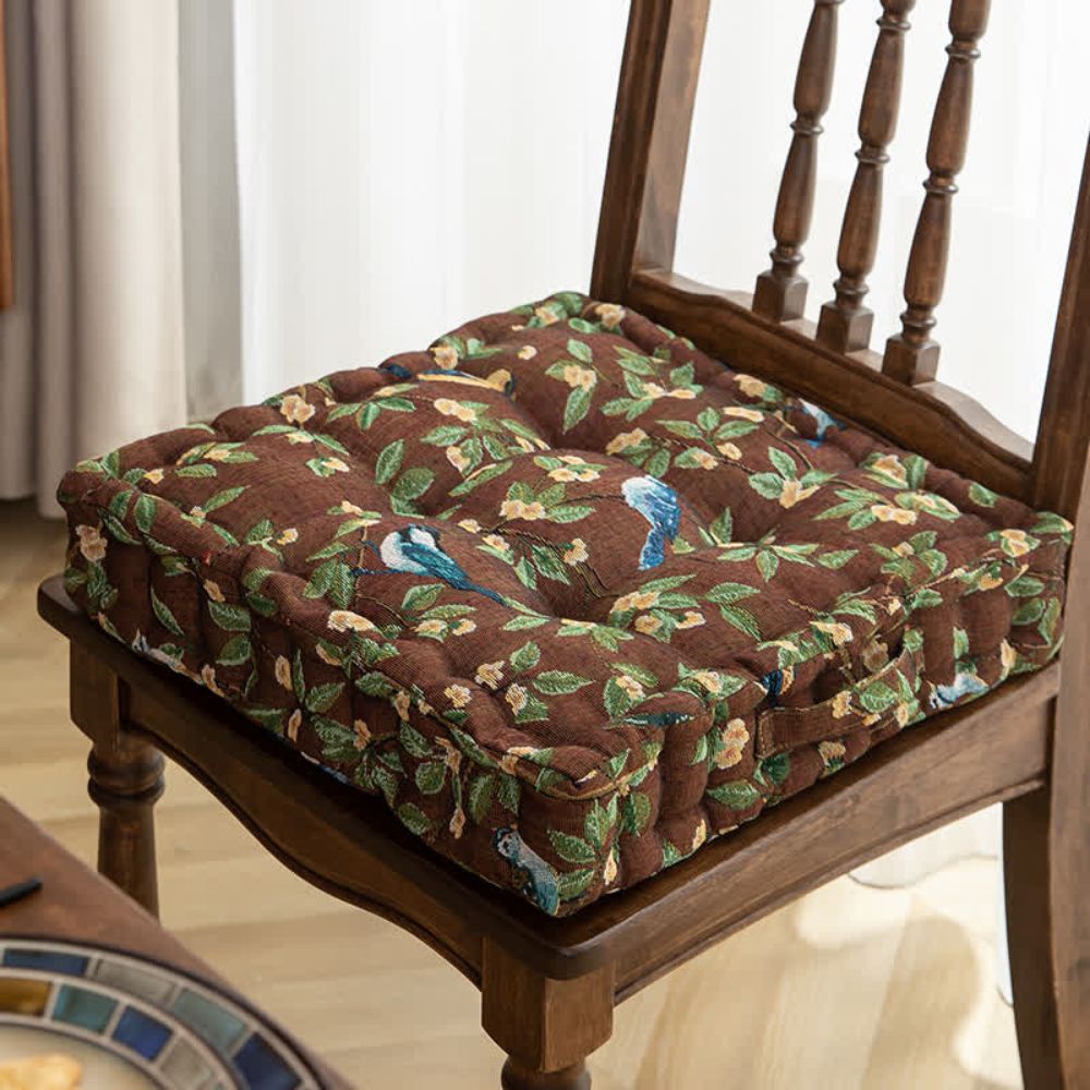 Coussin à fleurs colorées et oiseaux