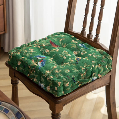 Coussin à fleurs colorées et oiseaux