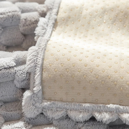 Close-up of textured gray and beige fabric with a polka dot pattern.