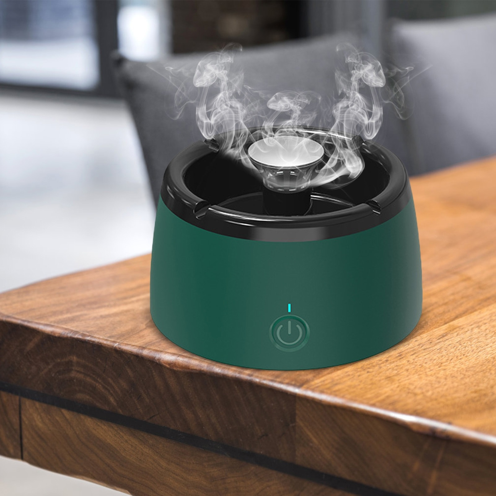 Green essential oil diffuser with steam on a wooden surface
